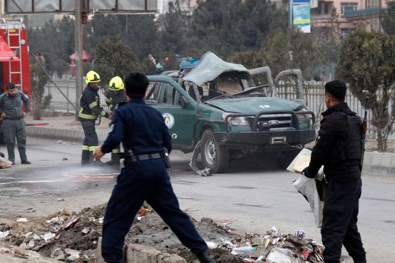 Policemen arrives at a site of a bomb blast which killed at least two people and injured five others, in Kabul on February 21, 2021. / AFP / -
