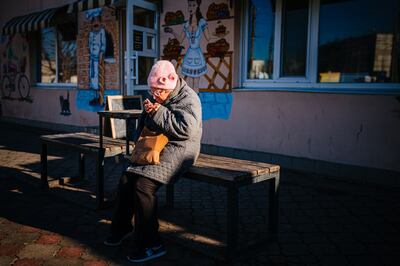 A woman on her phone in the city of Kherson, Ukraine, on December 31, 2022. AFP