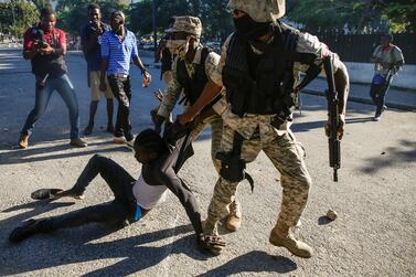 Police officers detain a man during protests against Haiti's President Jovenel Moise, in Port-au-Prince, Haiti, on February 8, 2021. Reuters