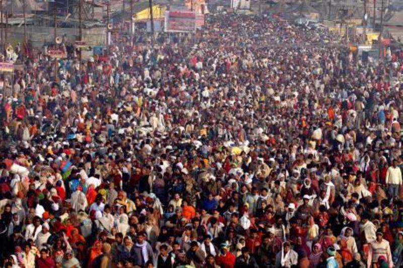 In this Wednesday, Feb.2, 2011, photo, thousands of Hindu devotees assemble on the bank of the River Ganges to take a holy dip, in Allahabad, India. According to UN Population Fund (UNFPA) the world population will reach seven billion Oct. 31, 2011. Already the second most populous country's with 1.2 billion people, India is expected to overtake China around 2030 when its population soars to an estimated 1.6 billion. (AP Photo/Rajesh Kumar Singh) *** Local Caption ***  India Seven Billion People.JPEG-04446.jpg