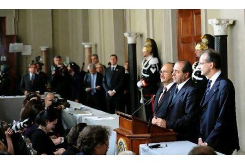 Leader of IDV, Antonio Di Pietro (2-R), speaks Sunday after consultations with the new Italian government after the resignation of Premier Silvio Berlusconi. He resigned after parliament gave final approval to austerity measures demanded by the European Union.