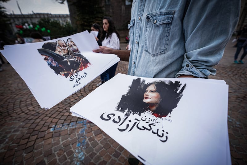 People attend a demonstration in solidarity with Mahsa Amini and other Iranian women in Castello Square, Turin. EPA