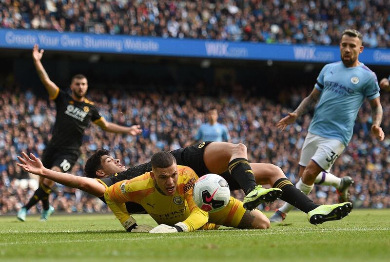 Wolverhampton Wanderers striker Raul Jimenez lands on the back of Manchester City goalkeeper Ederson. AFP