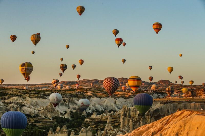 Hot air balloons carrying tourists rise into the sky at sunrise in Cappadocia, Turkey. Emrah Gurel/AP Photo