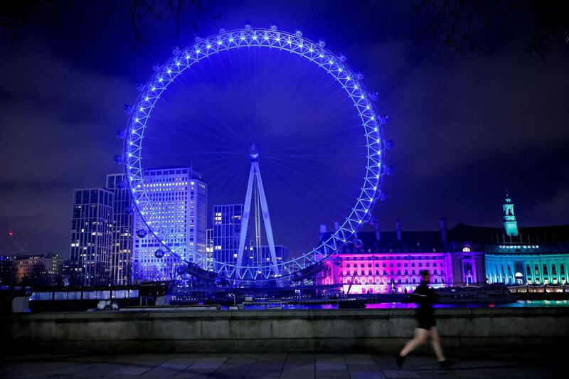 The London Eye tourist attraction is illuminated in blue light to celebrate to work of key workers, and those in Britain's NHS (National Health Service), in London as Britain continues its third national lockdown to stem the spread of COVID-19. Hospital chiefs in England were scrambling for hospital beds on Thursday as the surge in coronavirus cases risked overwhelming the system, healthcare providers and medics said.  AFP