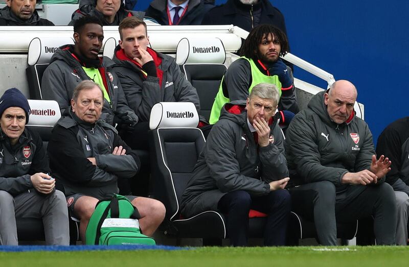 BRIGHTON, ENGLAND - MARCH 04: A tense looking Arsene Wenger manager / head coach of Arsenal watches the match with Danny Welbeck,Rob Holding and Mohamed Elneny of Arsenal on the bench behind him during the Premier League match between Brighton and Hove Albion and Arsenal at Amex Stadium on March 4, 2018 in Brighton, England. (Photo by Catherine Ivill/Getty Images)