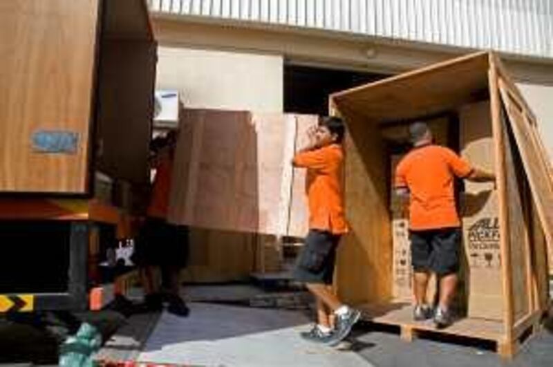 Dubai, UAE - June 4, 2009 - Movers load boxes into a truck to be shipped overseas by Allied Pickfords. Some shipping companies are busier than usual due to expatriate families leaving Dubai during the summer months. (Nicole Hill / The National) *** Local Caption ***  NH Moving05.jpg