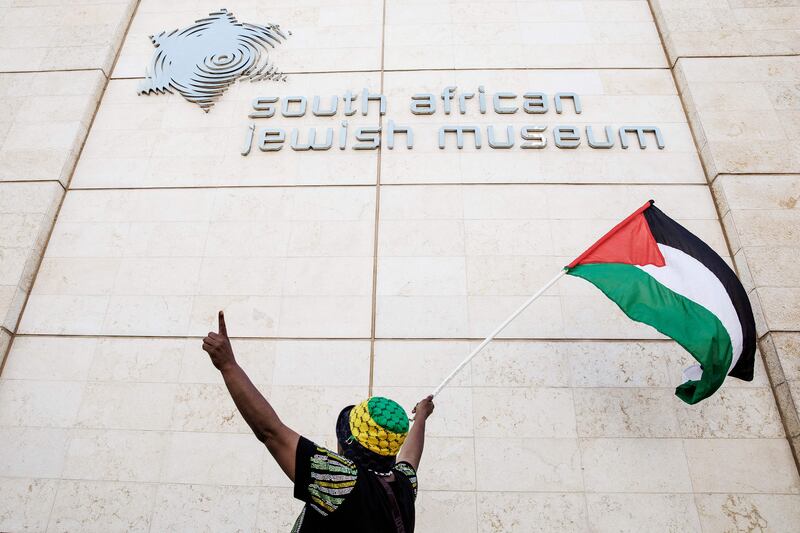 A South African activist waves a Palestinian flag during a demonstration in Cape Town. AFP
