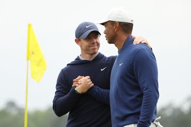 AUGUSTA, GEORGIA - APRIL 03: Rory McIlroy of Northern Ireland and Tiger Woods of the United States shake hands on the 18th green during a practice round prior to the 2023 Masters Tournament at Augusta National Golf Club on April 03, 2023 in Augusta, Georgia.    Christian Petersen / Getty Images / AFP (Photo by Christian Petersen  /  GETTY IMAGES NORTH AMERICA  /  Getty Images via AFP)