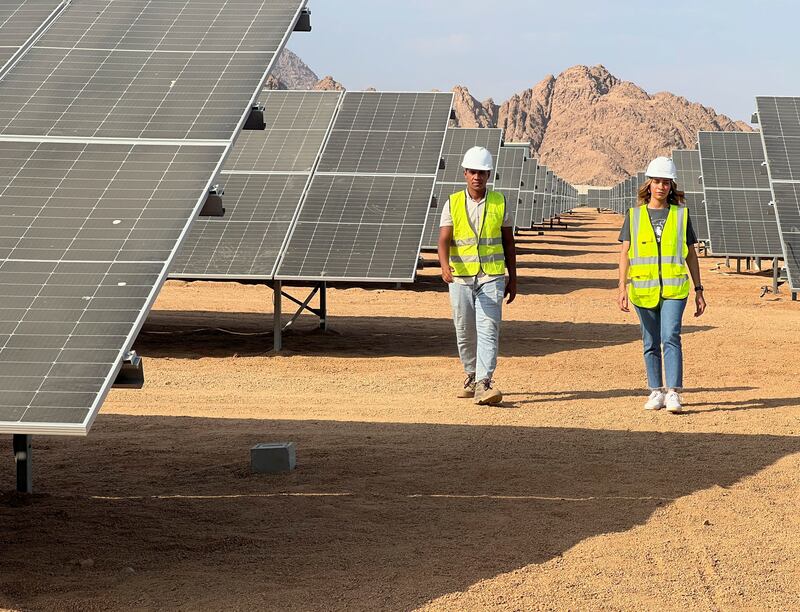 Engineers walk next to solar panels in Egypt. Reuters
