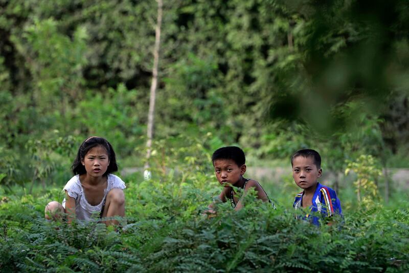 North Korean children look up from the side of a road on Thursday, July 20, 2017, in Hamhung, North Korea. Hamhung is North Korea's second largest city. (AP Photo/Wong Maye-E)