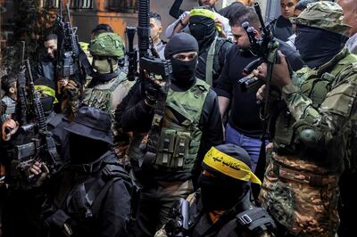 Palestinian fighters of the Aqsa Brigades attend the funeral of 16-year-old Palestinian Amir Odeh, who Israeli forces said 'threw a petrol bomb at troops from close range' at troops. AFP 