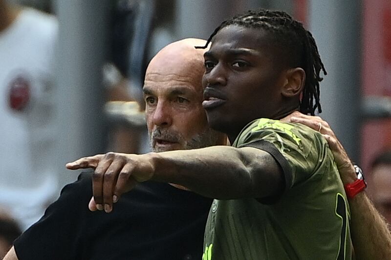 Rafael Leao, pictured with AC Milan manager Stefano Pioli, faces a fnitess test ahead of Wednesday's Champions League semi-final clash with city rivals Inter. AFP