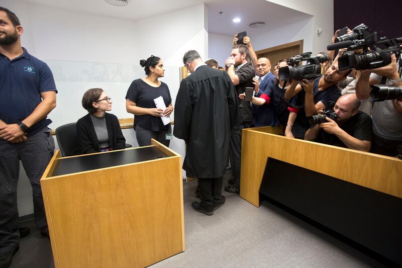 American Lara Alqasem, left, sits in a courtroom prior to a hearing at the district court in Tel Aviv, Israel, Thursday, Oct. 11, 2018. A senior Israeli cabinet minister on Wednesday defended the government's handling of the case of an American graduate student held in detention at the country's international airport for the past week over allegations that she promotes a boycott against the Jewish state. (AP Photo/Sebastian Scheiner)