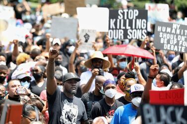 People join George Floyd's family in a march on Tuesday, June 2, 2020, from Discovery Green to City Hall in downtown Houston. Floyd died after being restrained by Minneapolis police officers on May 25. (Jon Shapley/Houston Chronicle via AP)