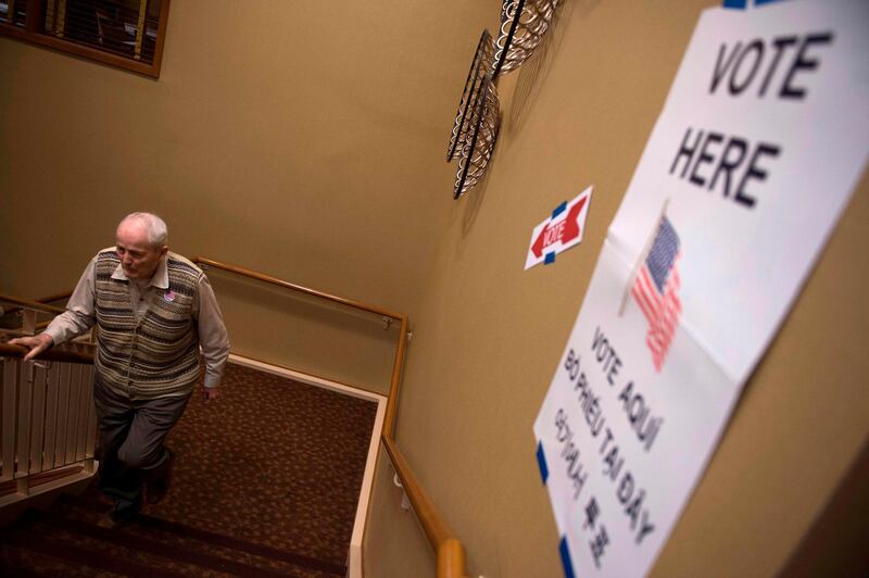 A retiree walks up stairs after voting at the Greenspring Retirement centre during the mid-term election day in Fairfax, Virginia. AFP