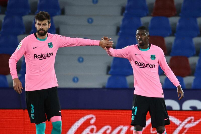 Barcelona's French forward Ousmane Dembele (R) celebrates with Gerard Pique after scoring Barca's third. AFP