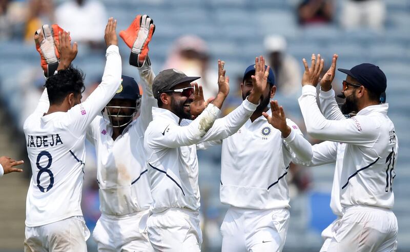 India's Ajinkya Rahane (C) celebrates with captain Virat Kohli (R) and teammates after taking a catch to dismiss South Africa's batsman Temba Bavuma during the fourth day of play of the second Test cricket match between India and South Africa, at the Maharashtra Cricket Association Stadium in Pune on October 13, 2019. ----IMAGE RESTRICTED TO EDITORIAL USE - STRICTLY NO COMMERCIAL USE-----
 / AFP / PUNIT PARANJPE / ----IMAGE RESTRICTED TO EDITORIAL USE - STRICTLY NO COMMERCIAL USE-----
