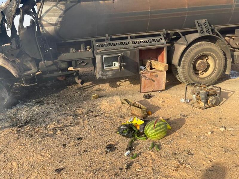 A handout picture showing a damaged lorry next to ammunition and fruit. Nearby lay a charred body. Photos: Iraqi Security Forces