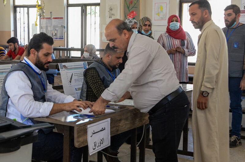 A man registers to vote at a polling station in the northern city of Mosul. Photo: AFP