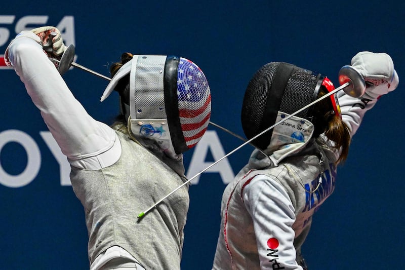 American Maia Weintraub and Sera Azuma of Japan compete in the Women's Team Foil event bronze medal match at the FIE Fencing World Championships in Milan. AFP