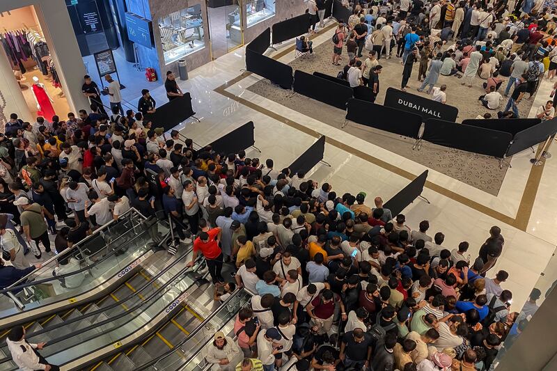 Crowds wait in line at the Dubai Mall Apple Store. Antonie Robertson / The National