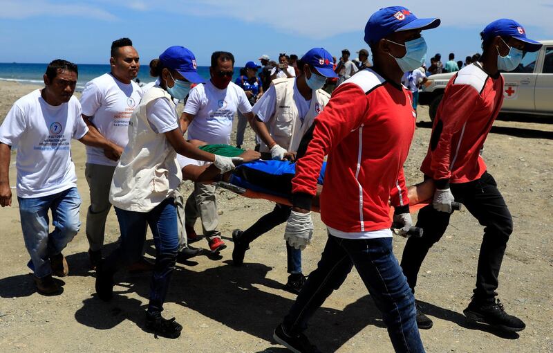 Volunteers and officials participate during an earthquake and tsunami drill on a beach in Dili, East Timor