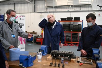 Britain's Prime Minister Boris Johnson (C) gestures in the automotive shop during a visit to Kirklees College Springfield Sixth Form Centre in Dewsbury, West Yorkshire, Britain June 18, 2021. Oli Scarff/Pool via REUTERS
