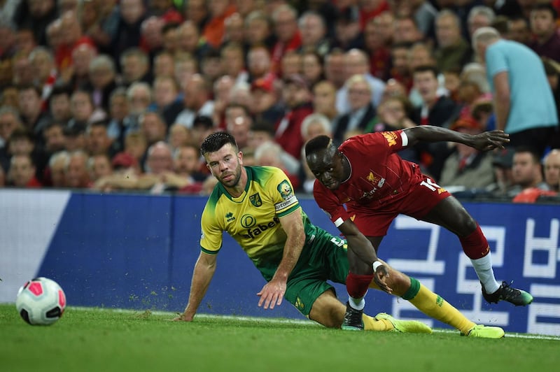 Norwich City defender Grant Hanley vies with Liverpool striker Sadio Mane during the Premier League game at Anfield. AFP