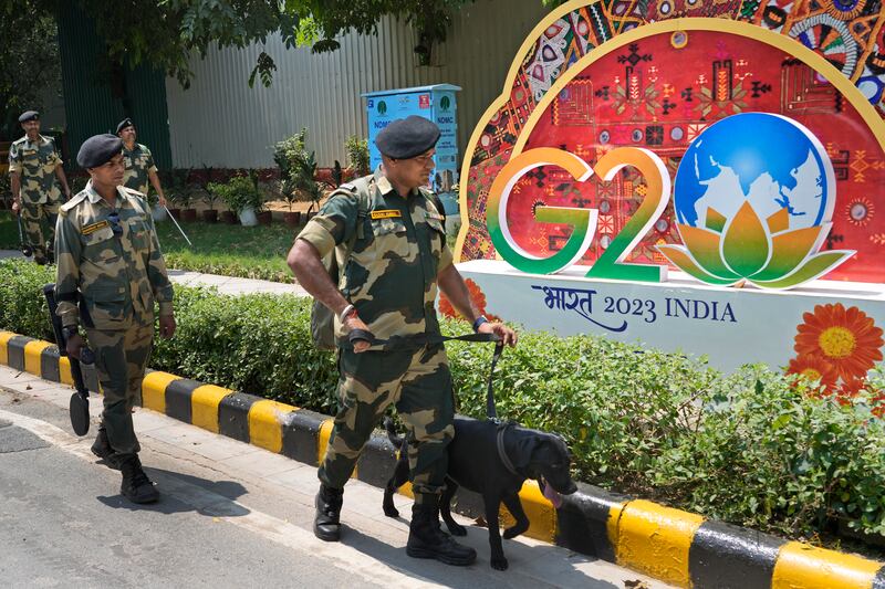 Indian paramilitary soldiers with a sniffer dog frisk the area near the venue ahead of this week's summit of the Group of 20 nations, in New Delhi, India. AFP
