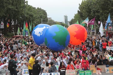 Environmental activists carry earth balloons during a rally demanding action in halting the climate crisis in Seoul, South Korea, on Saturday, September 21, 2019. AP 