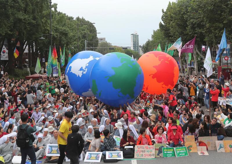 Environmental activists carry earth balloons during a rally demanding action in halting the climate crisis in Seoul, South Korea, Saturday, Sept. 21, 2019. Hundreds of activists attended a rally as a part of global climate strike ahead of a U.N. climate summit in New York. (AP Photo/Ahn Young-joon)