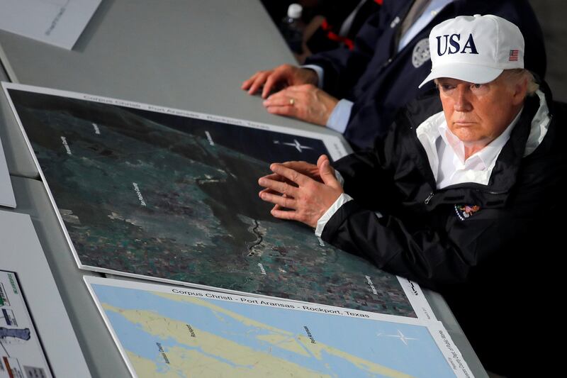 US president Donald Trump receives a briefing on Tropical Storm Harvey relief efforts in Corpus Christi, Texas. Carlos Barria / Reuters