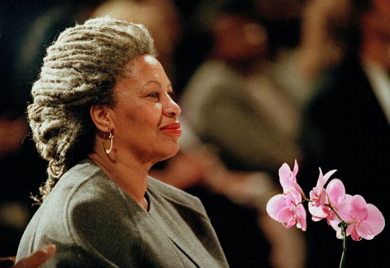 FILE - In this  April 5, 1994 file photo, Toni Morrison as she holds an orchid at the Cathedral of St. John the Divine in New York. On being awarded the 1993 Nobel Prize in Literature, Morrison's work was praised for its "visionary force and poetic import" and for giving "life to an essential aspect of American reality." Her novels, such as "Beloved," have shone a light on the racial prejudices that have afflicted her homeland. This year's winner is set to be announced on Thursday, Oct. 5, 2017. (AP Photo/Kathy Willens, File)
