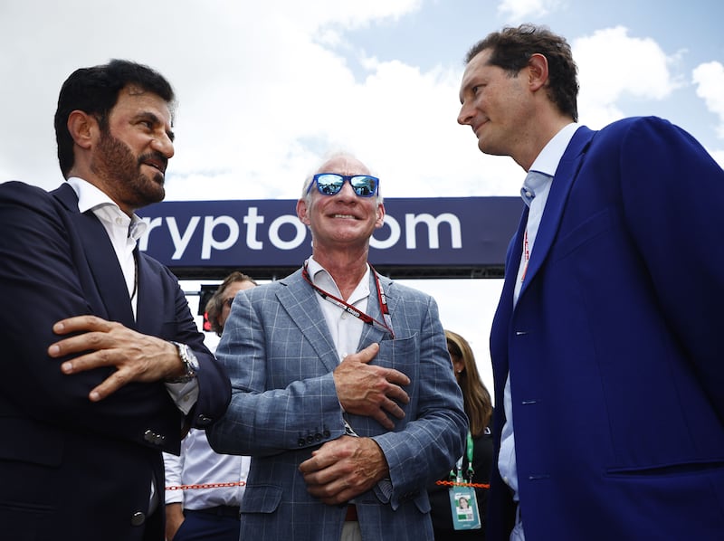 FIA president Mohammed Ben Sulayem, Liberty Media president and chief executive officer Greg Maffei, and Ferrari chairman John Elkann talk on the grid ahead of the F1 Grand Prix of Miami at the Miami International Autodrome on May 08, 2022 in Miami, Florida. AFP
