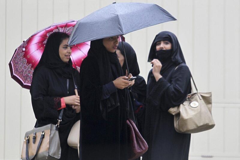 Women hold umbrellas on a rainy day in Riyadh. Faisal Al Nasser / Reuters