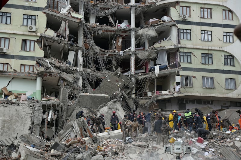 Rescue workers search for survivors under the rubble in Diyarbakir. Reuters