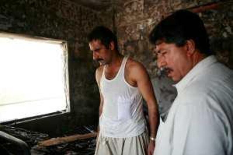 Abu Dhabi - September 20, 2009: Tariq Mohammed, from Pakistan surveys the damage to his room after a fire in his flat located across from Al Wahda Mall. ( Philip Cheung / The National )  *** Local Caption ***  PC0340-Fire.jpg
