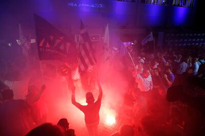 Supporters of the New Democracy party celebrate on election night in Athens. EPA 