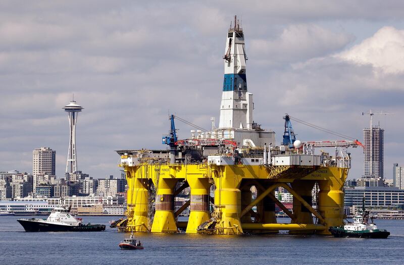FILE - In this May 14, 2015, file photo, the oil drilling rig Polar Pioneer is towed toward a dock in Elliott Bay in Seattle. Sharply lower oil prices are sending ripples through the global economy, lending more spending power to consumers _ particularly for Americansâ€™ big holiday shopping spree _ but potentially dampening investment in U.S. oil production. (AP Photo/Elaine Thompson, File)