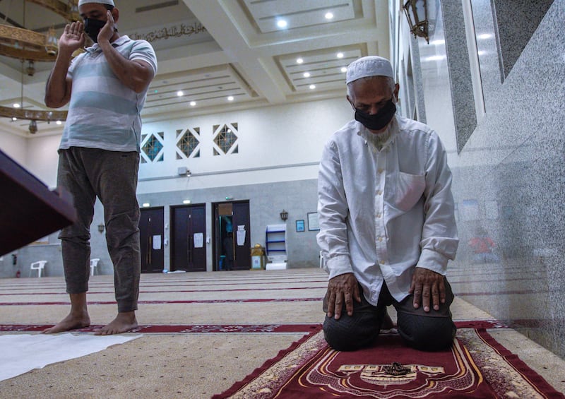 A worshipper kneels in prayer.