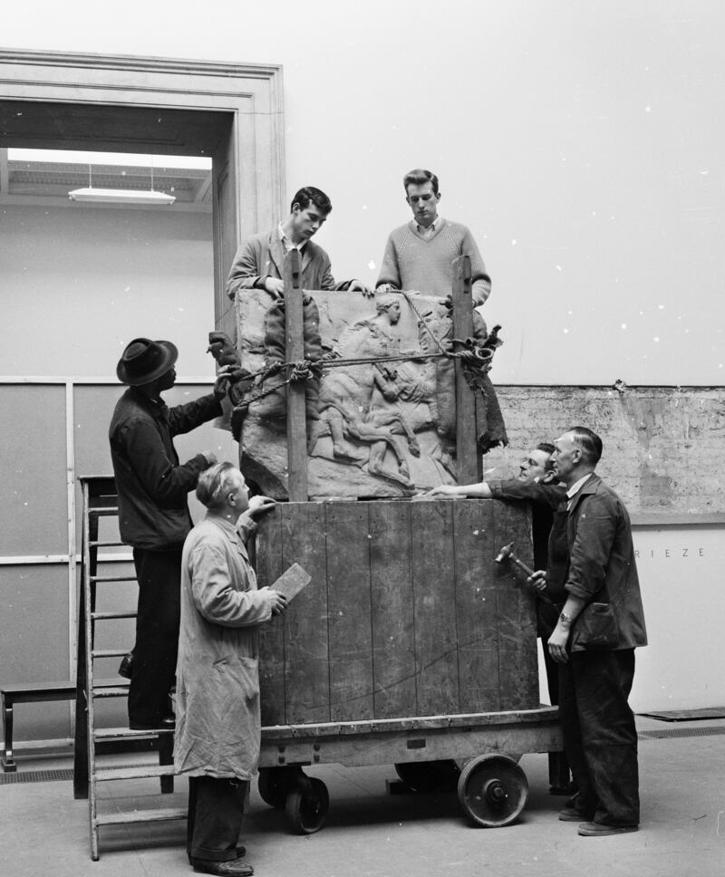 Workmen unload a portion of the Parthenon frieze before affixing it to the wall in the new Elgin Marbles room in 1961