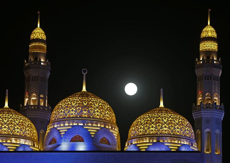 The supermoon rises above the Bahwan mosque in the Omani capital Muscat. Mohammed Mahjoub / AFP