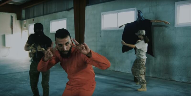 One of the scene's from Iraqi-Kiwi rapper I-NZ's new video 'This is Iraq', which depicts an Iraqi prisoner in an orange jumpsuit and some of the most haunting images from the US invasion of the country. I-NZ / YouTube