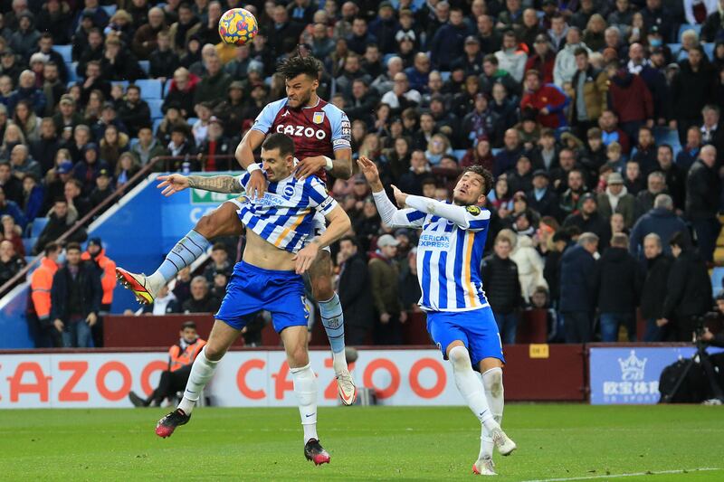 Aston Villa's Tyrone Mings, second left, vies with Brighton's defender Lewis Dunk. AFP