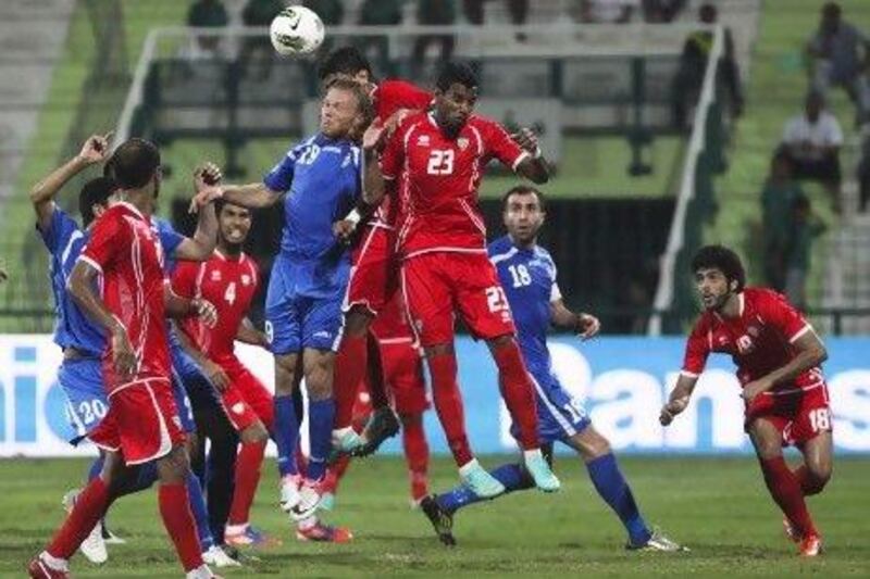 The UAE, in red, and Uzbekistan drew 2-2 in a friendly international at Al Shabab's stadium in Dubai last night. Lee Hoagland/The National