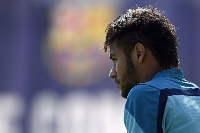 Neymar looks out at the pitch during Barcelona's training session ahead of their meeting with Atletico Madrid. Lluis Gene / AFP / May 16, 2014