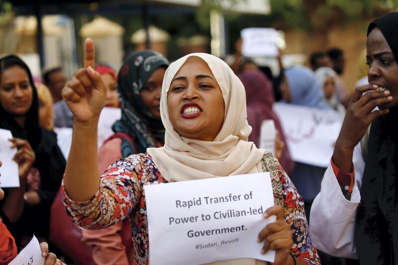 A Sudanese health worker carries a placard as scores of medics hold a rally in front of a hospital in the capital Khartoum on May 23, 2019. - Sudan's protest leaders said today they will seek advice from demonstrators camped outside the army headquarters on how to break a deadlock in talks with the military on installing civilian rule.
Medics along with engineers and teachers played a key role in nationwide protests against Omar al-Bashir's rule by forming the Sudanese Professionals Association, the group that initially launched the anti-Bashir campaign. (Photo by ASHRAF SHAZLY / AFP)