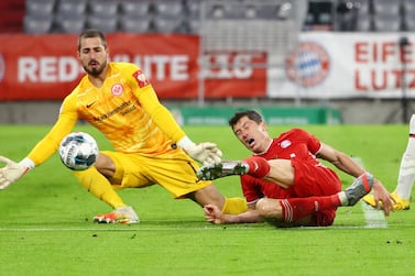 Bayern Munich's Robert Lewandowski, right, in action against Eintracht Frankfurt goalkeeper Kevin Trappduring during the German Cup semi-final. AP