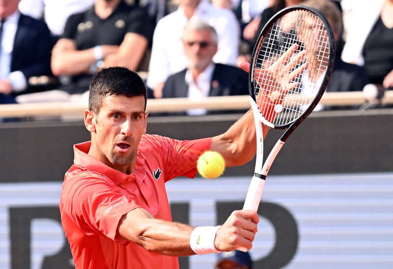 Novak Djokovic  plays a shot on his way to victory over Casper Ruud. EPA